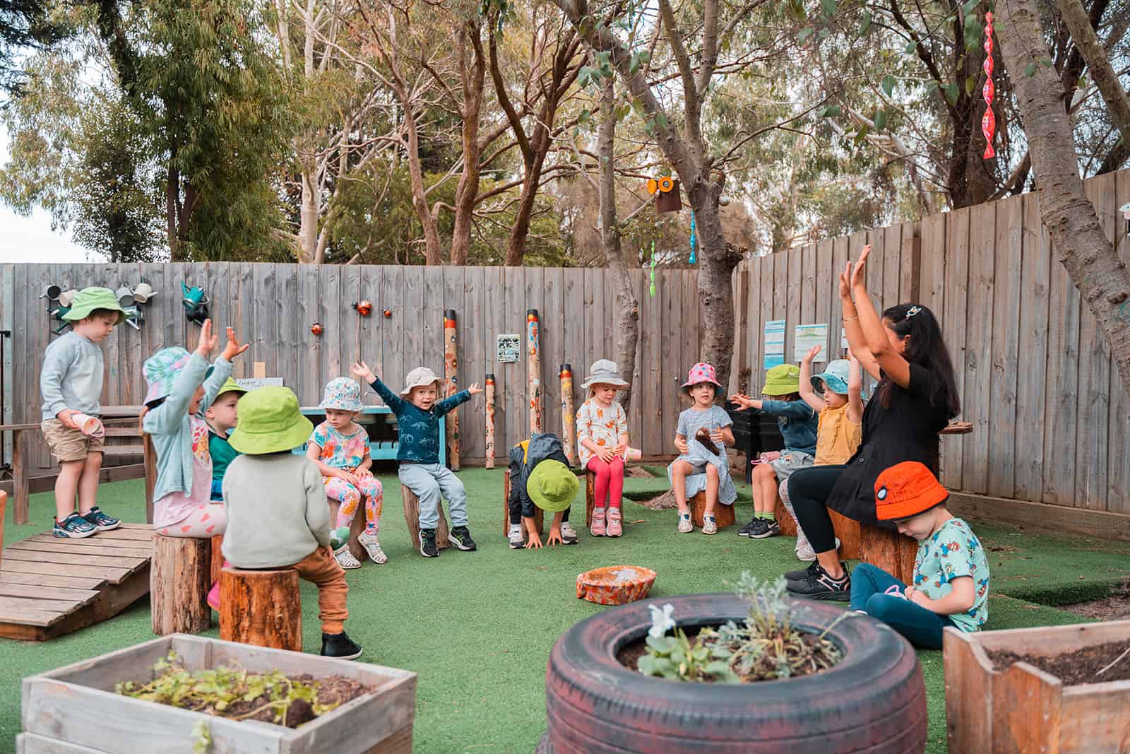 Outdoor learning session with the teacher and children.